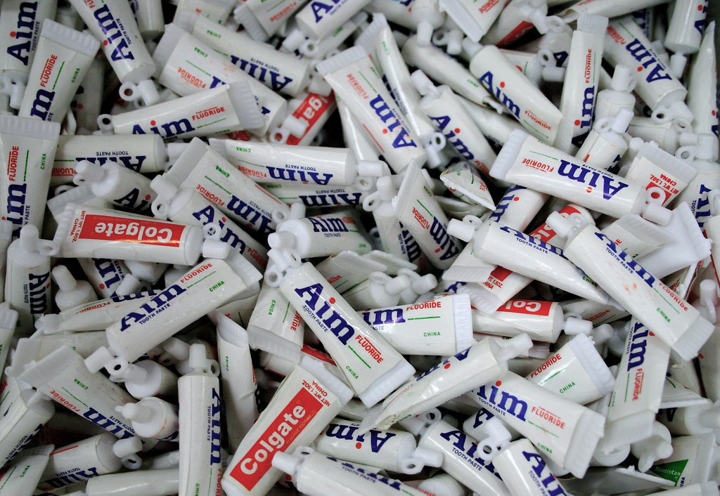 Hundreds of travel toothpaste tubes in a pile