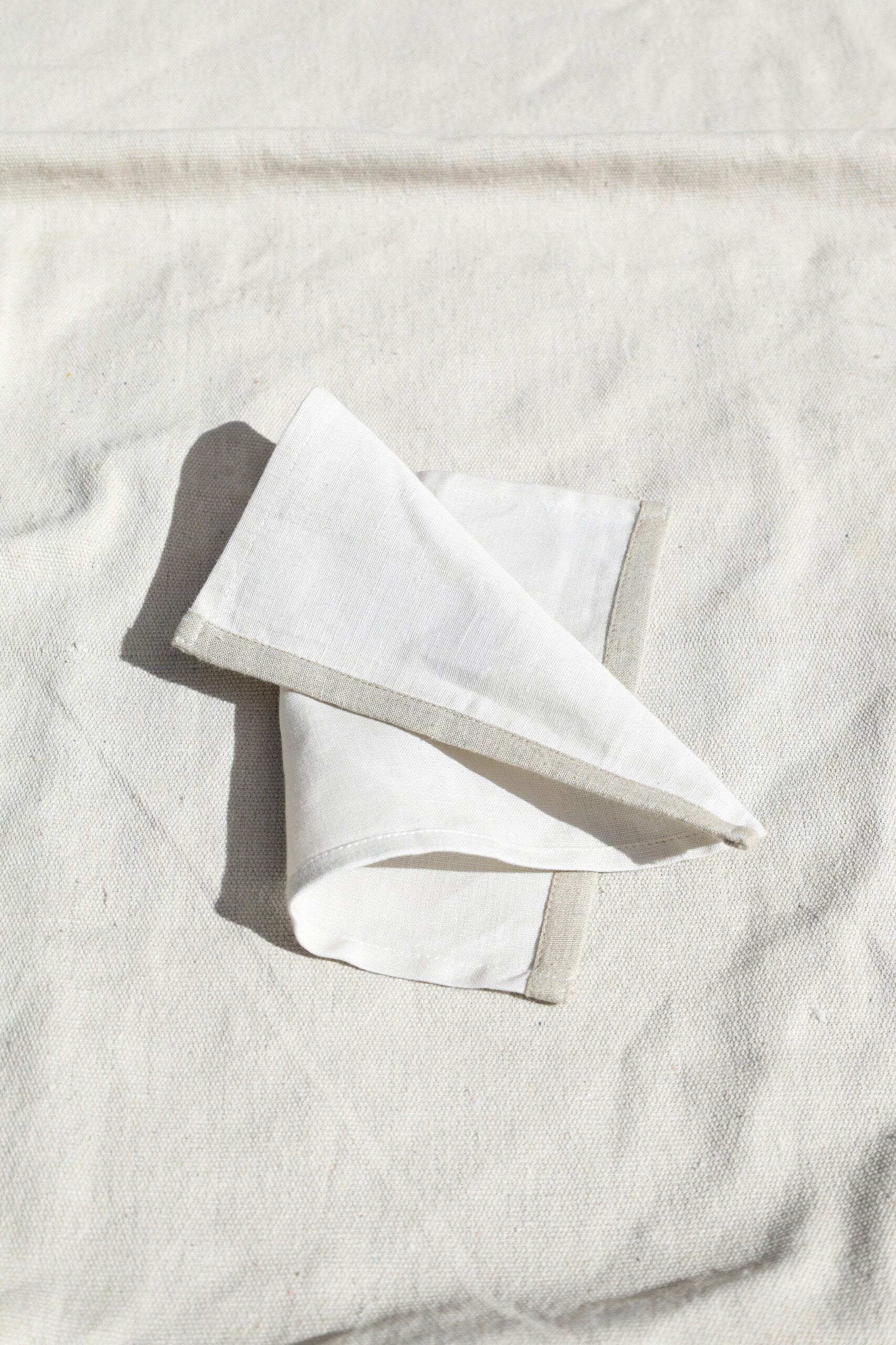 Photo of a white handkerchief on a white linen background