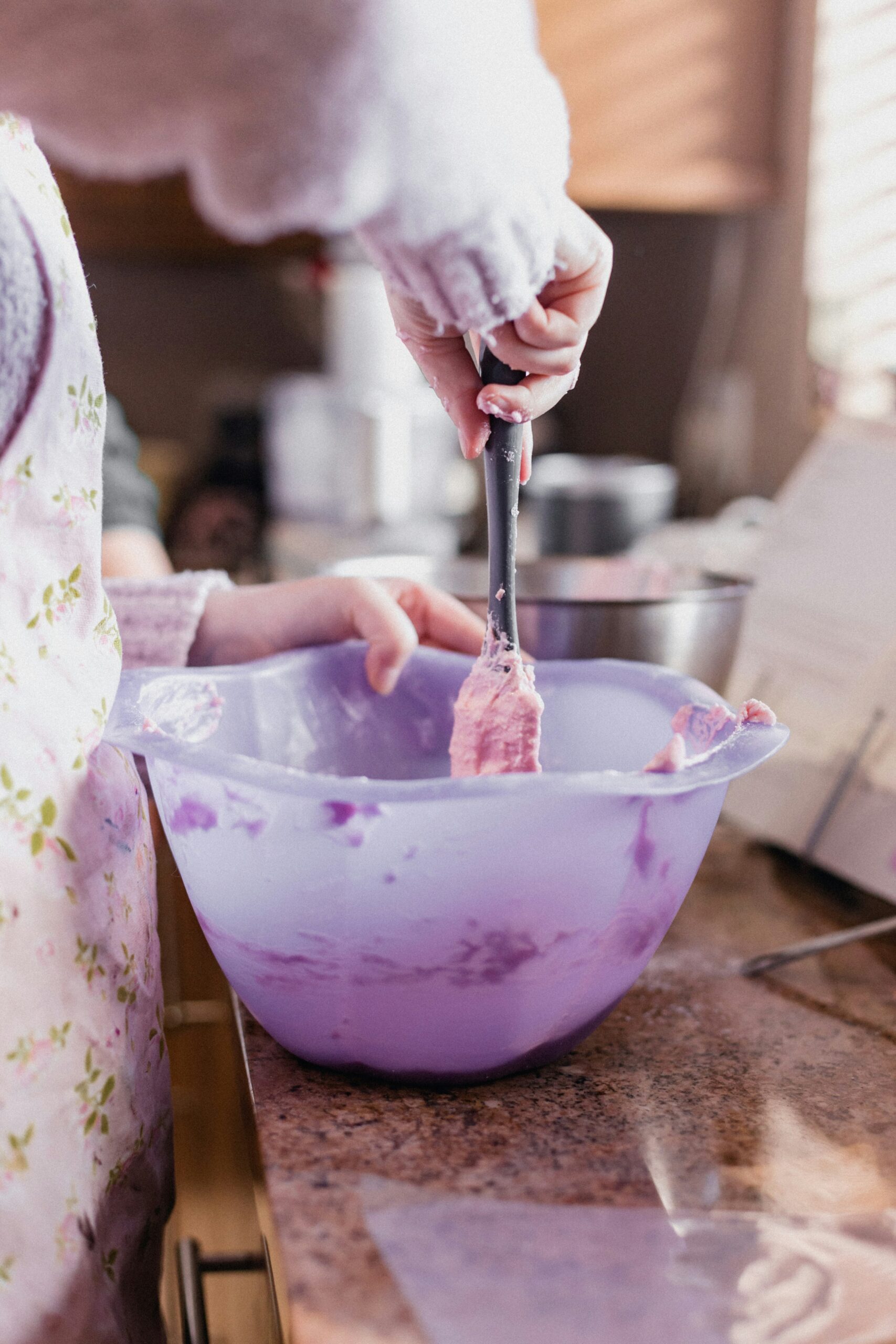 Person using a mixing bowl with a spatula