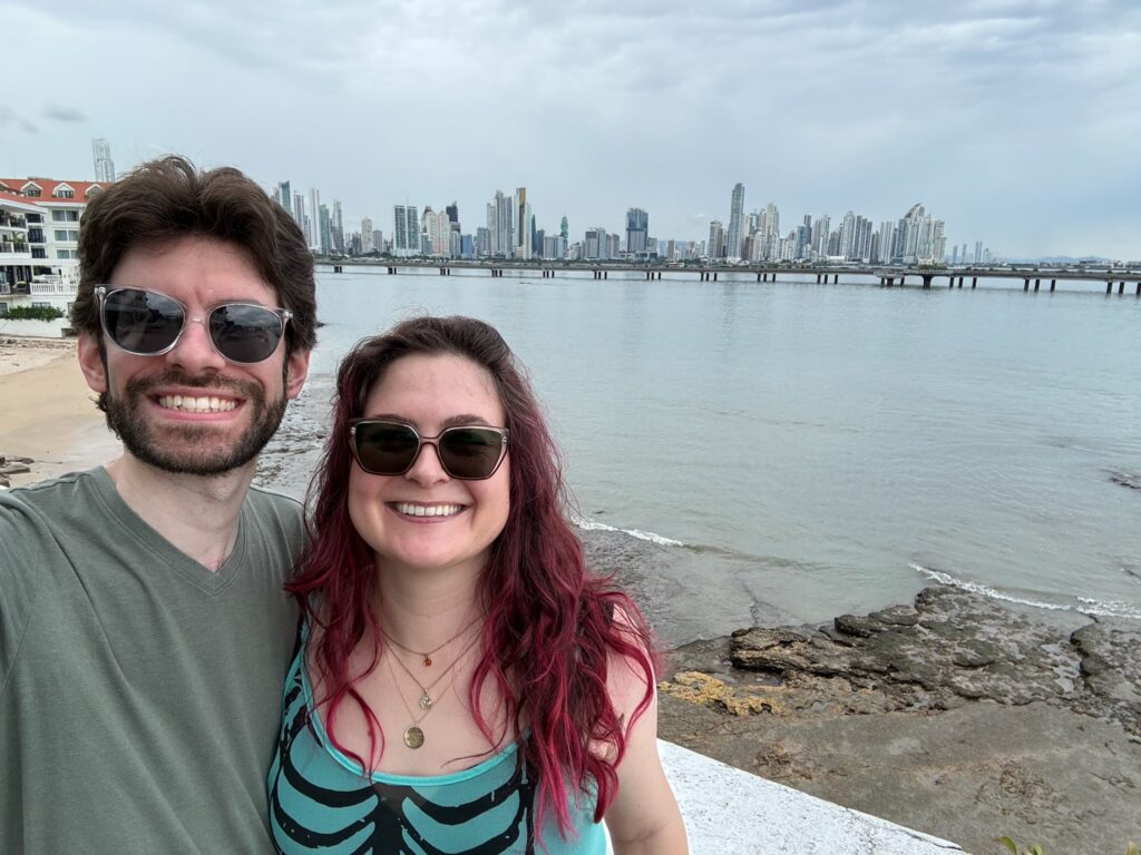 Man and woman with the city skyline in the background.